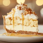 A slice of banana pudding crunch cheesecake with caramel drizzle