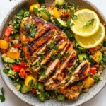 Grilled lemon herb chicken over quinoa salad